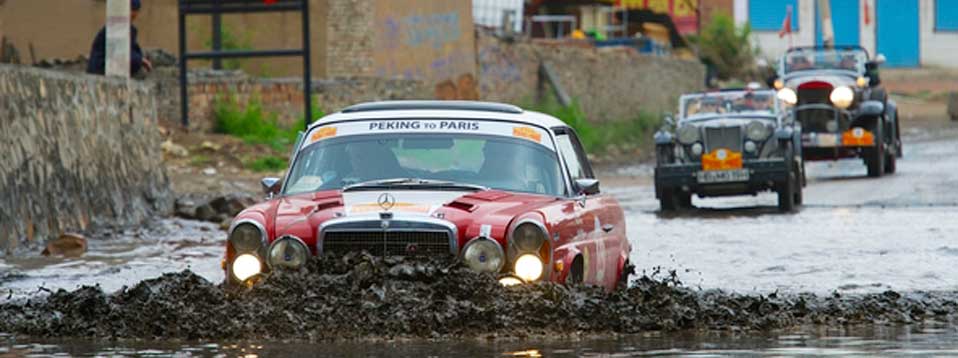 Floodwater at the start of the Paris to Peking Rally threatens drivers progress